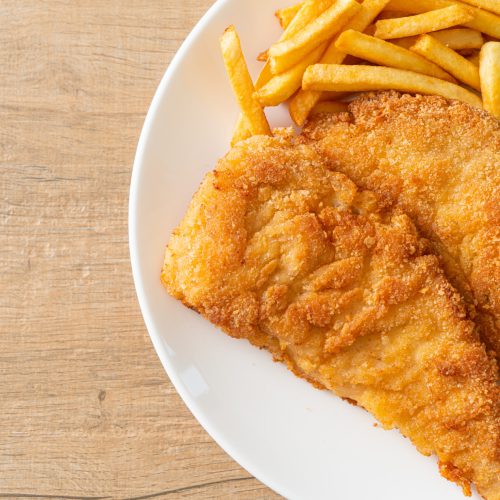 Homemade Breaded Weiner Schnitzel with Potato Chips - Fried Chicken with french fries - European food style
